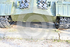 Tank wheels close-up. Iron tracks of a heavy military tank. Iron caterpillars and wheels of a military heavy tank. View of the