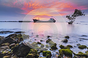 Tanker and barge in burning  sunset