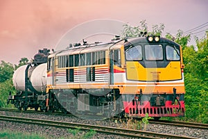 Tanker-freight car with diesel locomotive on the railway.
