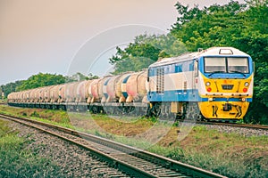 Tanker-freight train by diesel locomotive at the railway station.