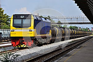 Tanker-freight train by diesel locomotive on the railway yard