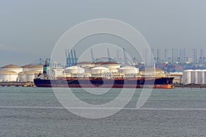 Tanker in front of an oil refinery plant
