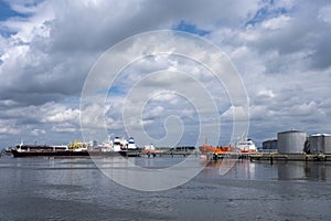 Tanker and oil storage tanks in Rotterdam, Netherlands. The port is the largest in Europe and facilitate the needs of a hinterland