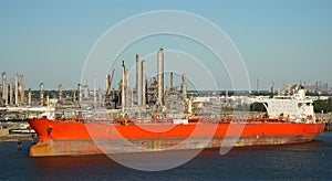 Tanker ship in front of an oil refinery