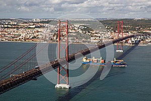 Tanker ship passes under the The 25 April bridge