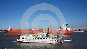 Tanker ship passing the Creole Queen on the Mississippi River in New Orleans