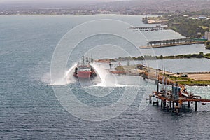 Tanker supporting with the supply of water for the extinction of the fire at the supertanker base