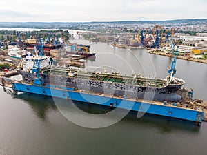 Tanker vessel repair in dry dock Shipyard, aerial view