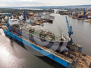Tanker vessel repair in dry dock Shipyard, aerial view