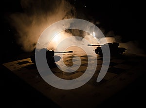 Tanks in the conflict zone. The war in the countryside. Tank silhouette at night. Battle scene.