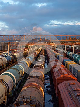 Tanks with fuel on the railway tracks at sunset. Sunset at the train station.