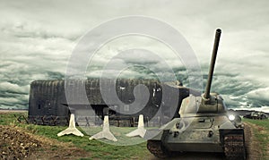 Tanks T-34 in front of Czechoslovak border fortifications with the Czech hedgehogs and damaged self-propelled gun ISU