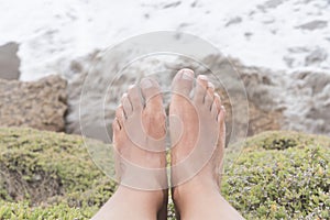 Tanned feet of a girl in a natural environment, on vacation, on the coast