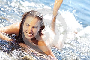 Tanned girl in the surf