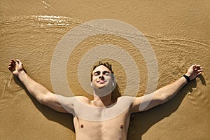 Tanned guy on beach