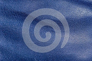 Tanned leather is painted blue. Blue leather background macro. The texture is blue