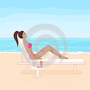 tanned woman lying on the chaise lounge and sunbathing on the beach