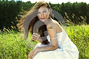 Tanned woman in white summer dress