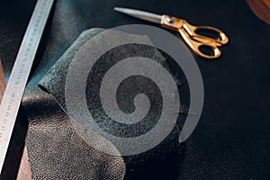 Tanner tools leather goods on workshop. Working process of leather craftsman