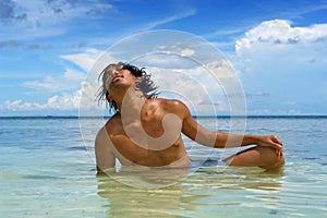 Tanning in sea on tropical beach