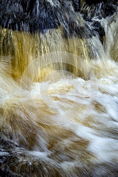 Tannins turn a waterfall amber in Colchester, Connecticut in autumn