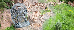 Tantric Deities statue in Ritual Embrace located in a mountain g