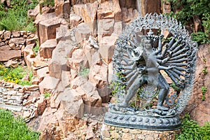 Tantric Deities statue in Ritual Embrace located in a mountain g