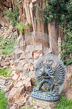 Tantric Deities statue in Ritual Embrace located in a mountain g