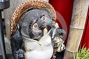 Tanuki statue out front of a business in Japan