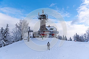 Tanvaldsky Spicak Mountain with lookout tower. Ski resort at winter time, Czech Republic