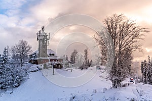 Tanvaldsky Spicak Mountain with lookout tower. Ski resort at winter time, Czech Republic