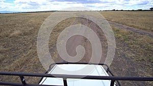 Tanzania, African Safari, Driving All-terrain Vehicle on Dusty Road POV