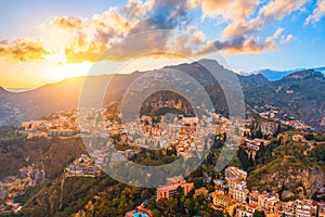 Taormina is a city on the island of Sicily, Italy. Aerial view from above in the evening at sunset