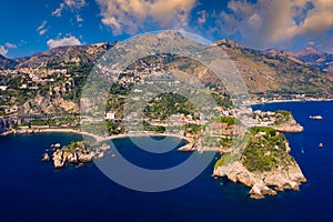 Taormina is a city on the island of Sicily, Italy. Mount Etna over Taormina cityscape, Messina, Sicily. View of Taormina located