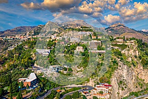 Taormina is a city on the island of Sicily, Italy. Mount Etna over Taormina cityscape, Messina, Sicily. View of Taormina located