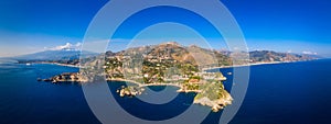 Taormina is a city on the island of Sicily, Italy. Mount Etna over Taormina cityscape, Messina, Sicily. View of Taormina located