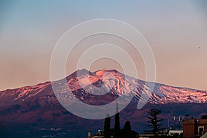 Taormina - Panoramic view of snow capped Mount Etna volcano during sunrise from Taormina, Sicily, Italy, Europe, EU