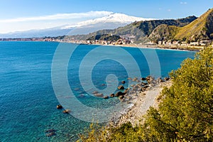 Taormina shore at Ionian sea with Giardini Naxos and Villagonia towns and Mount Etna in Messina region of Sicily in Italy