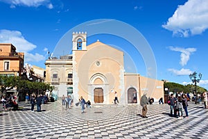 Taormina, Sicily, Italy - Apr 8th 2019: Tourists walking on the main square in the city center. Piazza IX Aprile is a popular