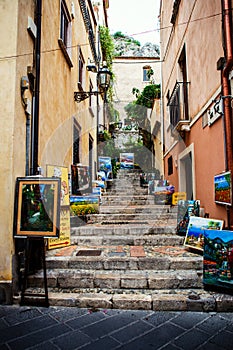 Taormina stairs street with paintings by local authors