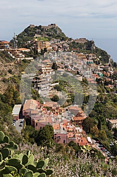 Taormina town on a mountain top in Sicily island on beautiful day