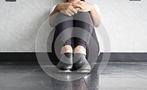 Tap dancer sitting down and holding her legs