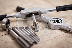 Tap die on a wooden table
