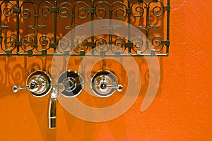 Tap and grates on orange background photo