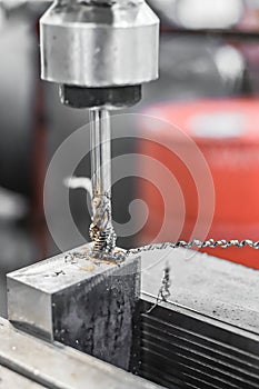 A tap on a machine for tapping a hole in a part