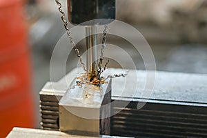 A tap on a machine for tapping a hole in a part