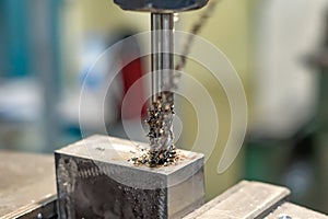 A tap on a machine for tapping a hole in a part