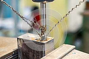 A tap on a machine for tapping a hole in a part