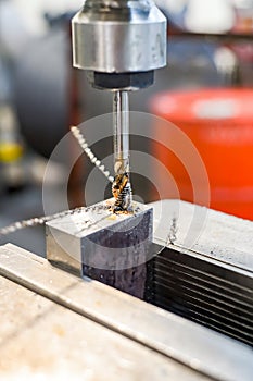 A tap on a machine for tapping a hole in a part