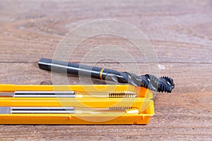 Metal threading taps. Tool for processing metal on a wooden board